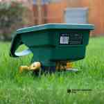green spreader on a lawn