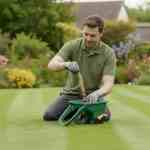 spreader fertiliser on a lawn